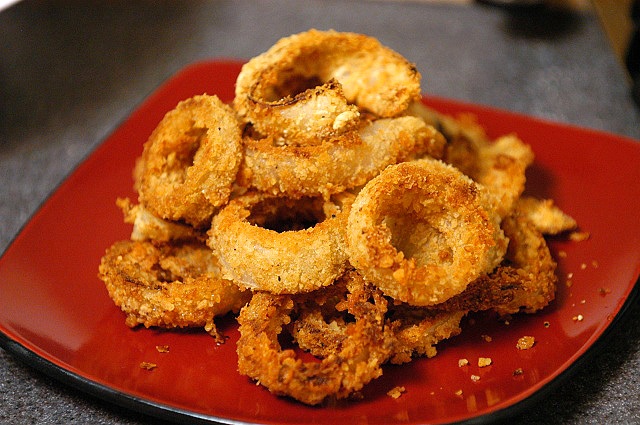 crispy oven fried onion rings on a red plate